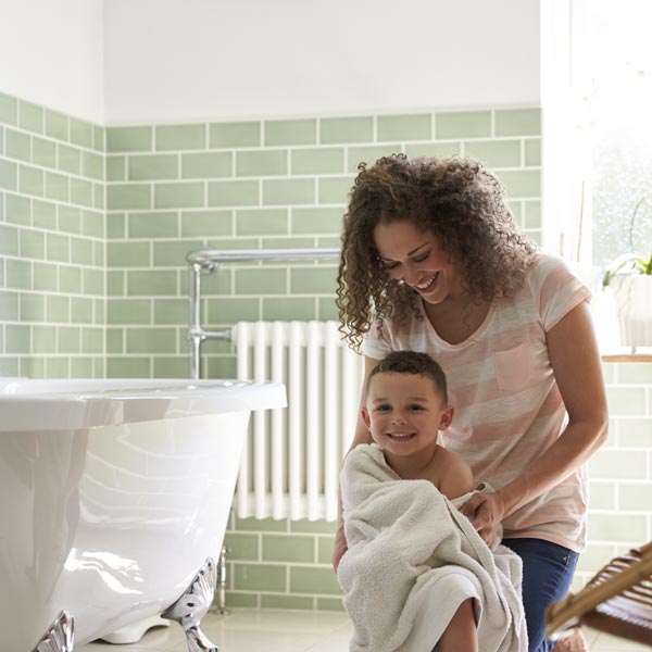 woman giving son a bath