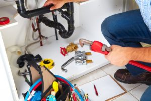 Plumber repairing the water pipe