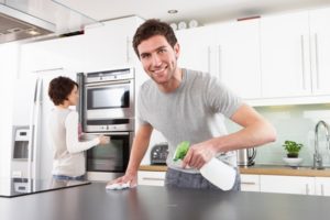 A boy cleaning the kitchen