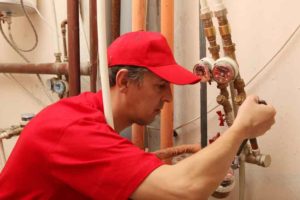 Plumber repairing the pipe