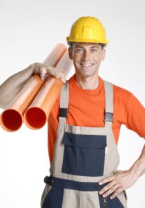 Plumber holding the pipes
