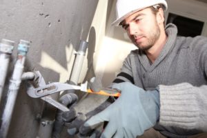 Plumber repairing the pipe