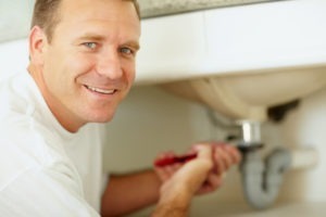 Plumber repairing the sink